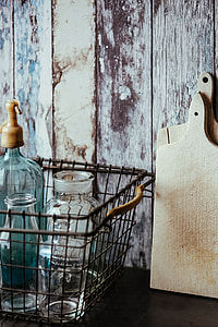 Collection of bottles in metal mesh basket thumbnail