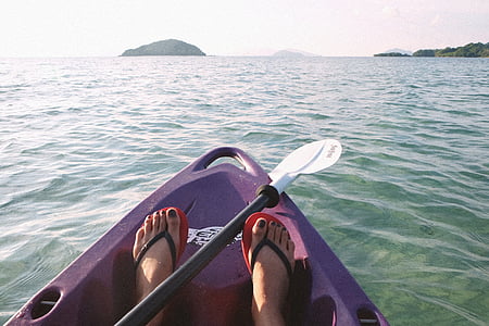 person riding purple sit-on-top kayak thumbnail