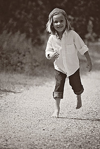 girl walking in shallow focus photography thumbnail