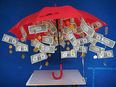 red umbrella with 1 US dollar banknotes and round gold-colored coins attached to strings thumbnail