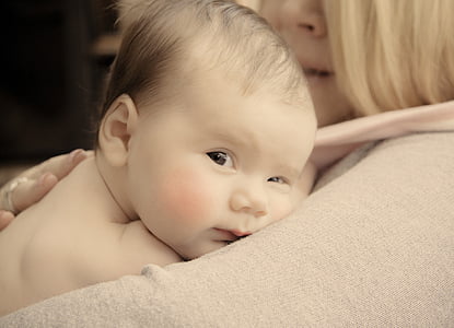 woman carrying newborn thumbnail