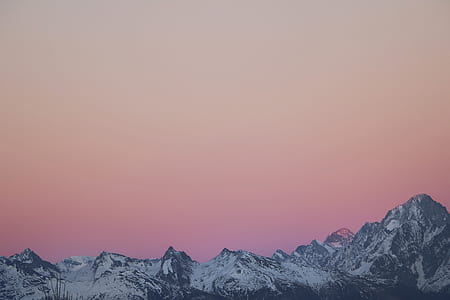 snowy mountain and pink sky during daytime thumbnail