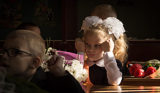 girl sitting near boy wearing eyeglasses thumbnail