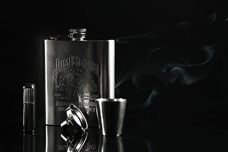 gray hip flask beside gray flip lighter thumbnail