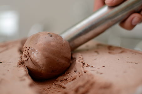 person scooping chocolate ice cream thumbnail