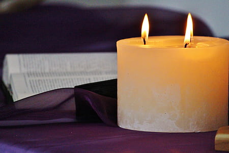 litted pillar candle on table thumbnail