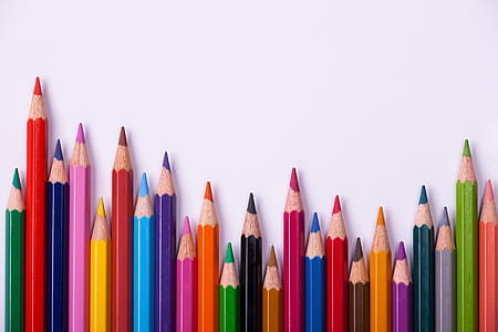 assorted-color pencils on white surface thumbnail