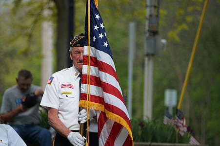 man holding American flag thumbnail