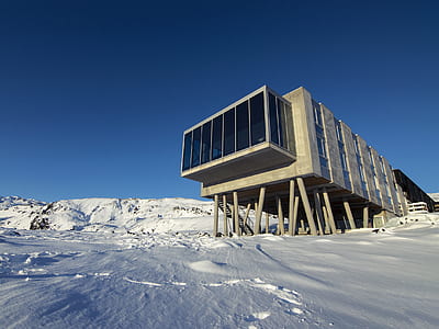 gray concrete house on ice land at daytime thumbnail