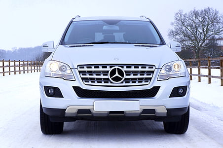 white Mercedes-Benz SUV on snow-covered road thumbnail