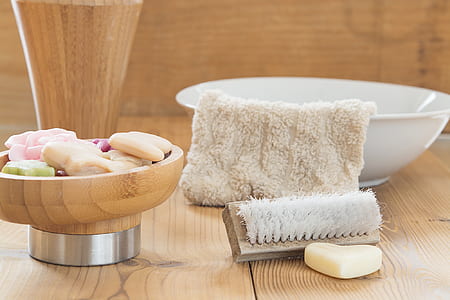 white towel on white ceramic basin with brown wooden brush thumbnail