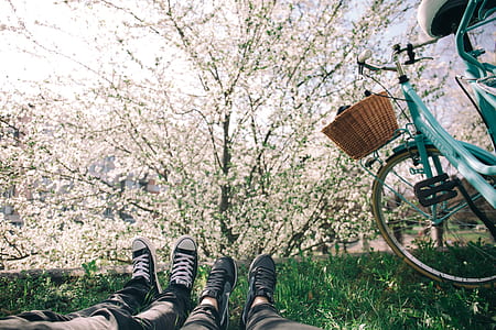 two person's laying on grass during daytime thumbnail
