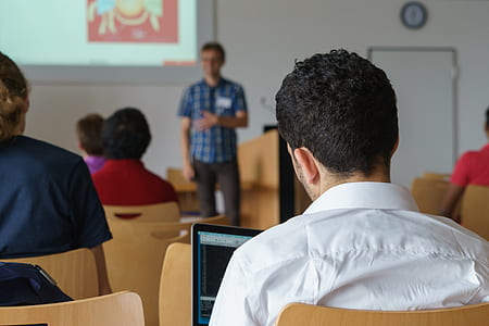 group of people sitting on chair while listening to person in front thumbnail