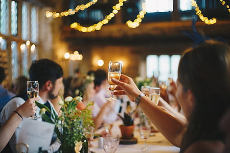 woman raising his hand while holding wine bottle thumbnail