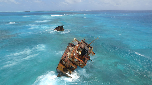 brown ship in the middle of the ocean thumbnail