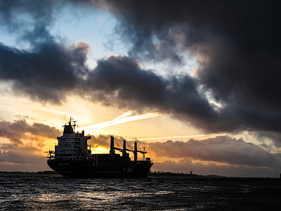 ship on body of water under cloudy sky thumbnail