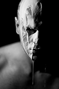 grayscale photo of man with white liquid on his face thumbnail