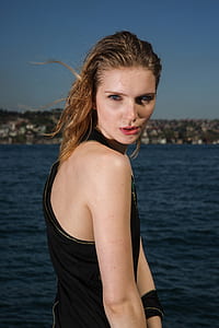 woman standing near body of water thumbnail