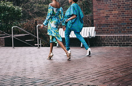 two woman walking on brick pavement at daytime thumbnail