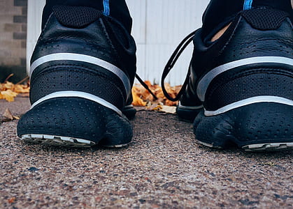 black-and-gray basketball shoes on gray concrete pavement thumbnail