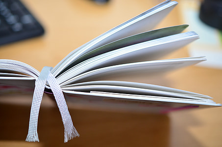selective focus photograph of book on wood surface thumbnail