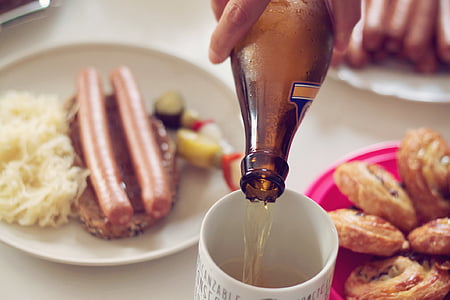 person pouring beer in white mug thumbnail