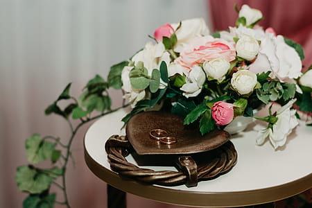 Two Gold Rings Near White And Pink Flowers thumbnail