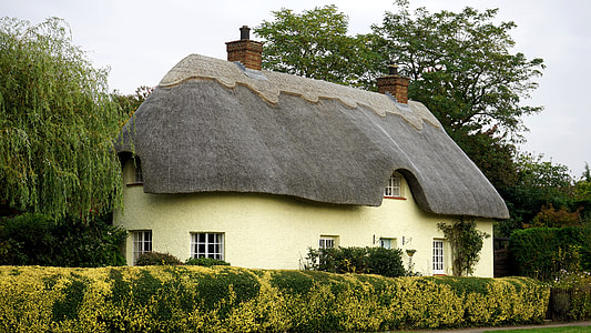 architectural photography of white concrete 2-storey house with attic and two brick chimneys thumbnail