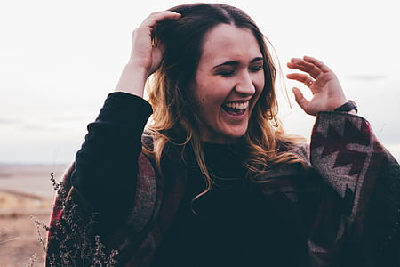 women closing eyes and smiling during daytime thumbnail