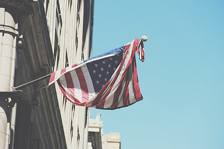 U.S.A flag hanged at the buildings corner area thumbnail