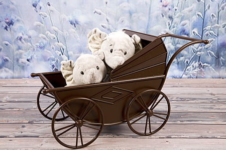 two white animal plush toys on brown carriage thumbnail