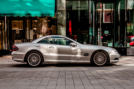 silver Mercedes-Benz SL-class parked on front of building thumbnail