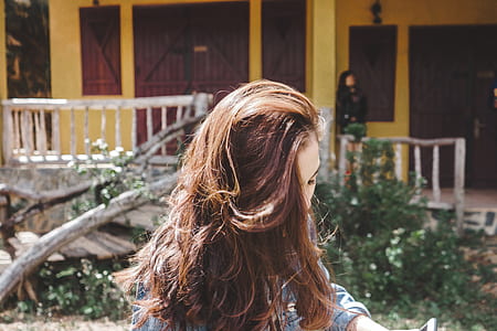 woman near house during daytime thumbnail