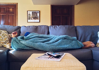 person lying on bed with blue fleece textile thumbnail