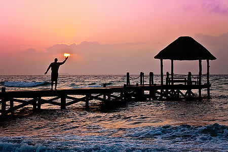 photo of man on dock during golden hour thumbnail