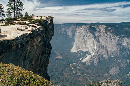 photography of trees beside mountain under white sky during daytime thumbnail