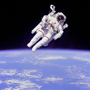 photo of astronaut floating above earth thumbnail