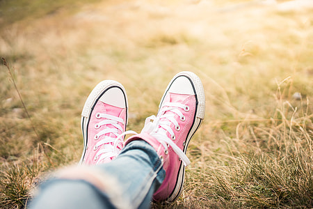 Girl With Pink Shoes Laying in Meadow thumbnail