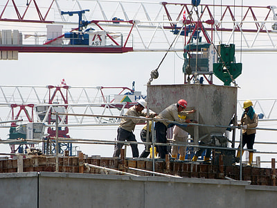 three men in front of industrial machine thumbnail