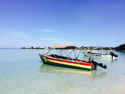 red, beige, and green boat on water at daytime thumbnail