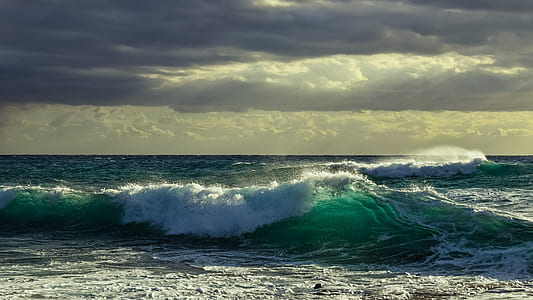 body of water waves under gray clouds thumbnail