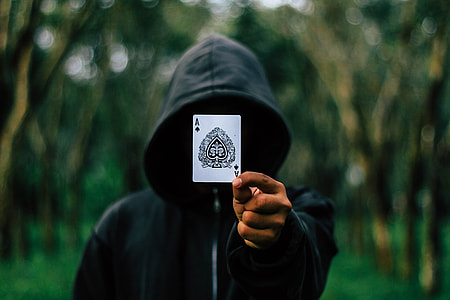 person holding ace of spade playing card thumbnail