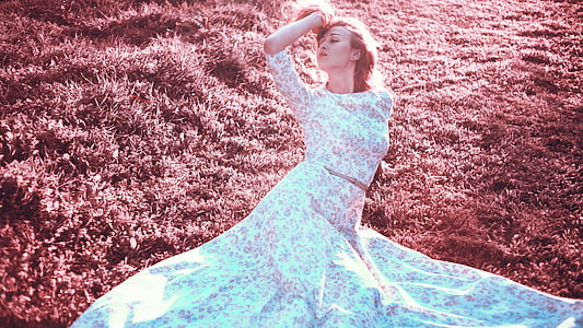 woman wearing white and pink floral 3/4 sleeved crop top and skirt laying on grass field thumbnail