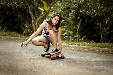 woman in white tank top riding wheel cutout longboard thumbnail