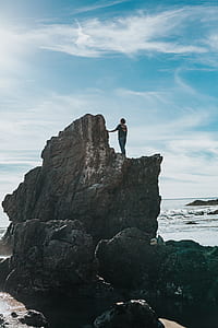 woman standing on rock formation thumbnail