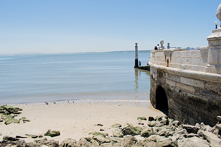 gray and white concrete building on seashore during daytime thumbnail