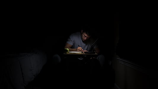man writing on book inside room thumbnail
