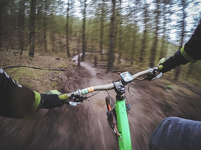 green mountain bicycle passing in the forest thumbnail