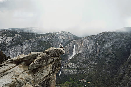 man sitting cliff edge thumbnail