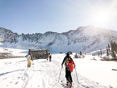 person holding snow skis and stick thumbnail